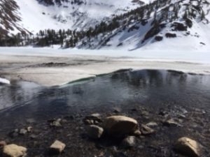 A Lake in Front of a Snow Covered Mountain