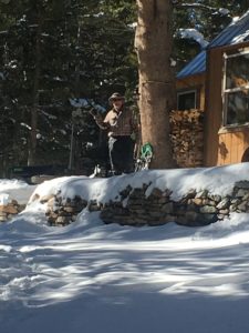 Frank Chopping the Side of a Tree in Front of a House