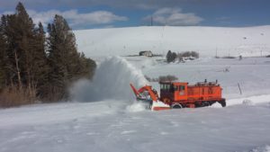 Plowing road to lower parking lot with a truck