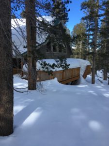 A Wooden Cabin With a Snow Covered on Tamarack