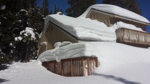 Cabin with lots of snow pilled on the surface