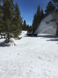 an excavator on the snow covered road