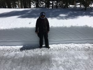 a man wearing helmet standing near snow