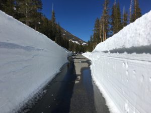 view of a clear road and snow around it