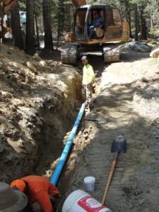 three men working on a pipeline project