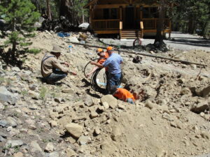 four men working on a pipeline project