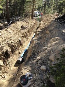 a long pipe being installed on the ground