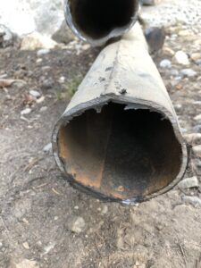 closeup shot of an iron pipe on the ground