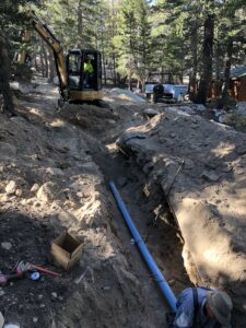 a man installing a long blue color pipe