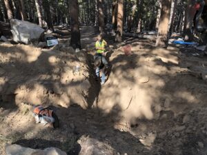 two men looking into a digged area