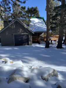 View of a Cabin on Tamarack surrounded by snow