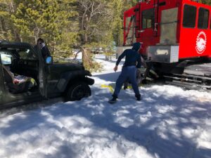 Red Color Jeep Clearing Snow on a Plain