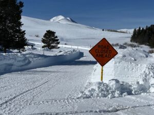 Road Closed Ahead Sign Board in the snow area