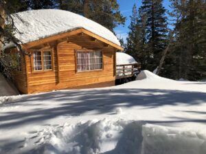 Second Story of a Wooden Cabin Buried in Snow