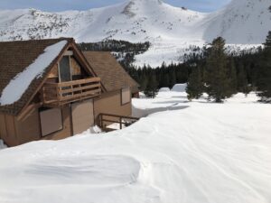 A Wooden House in a Pile of Snow Covered Plain