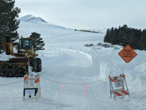 An Ice Pathway Entrance With a Road Closed Board