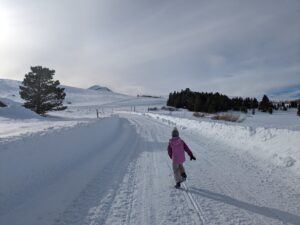 A Child Running on a Snow Pathway