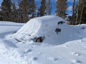 A Vehicle Parked in the Parking Lot Covered in Snow