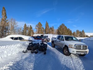 cars and bikes in the snow covered Parking lot