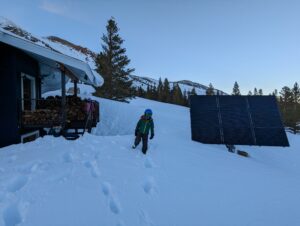 a kid with safety helmet is walking on the snow