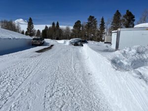 a snow covered Parking lot with two cars