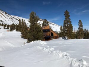 view of a house surrounded by snow