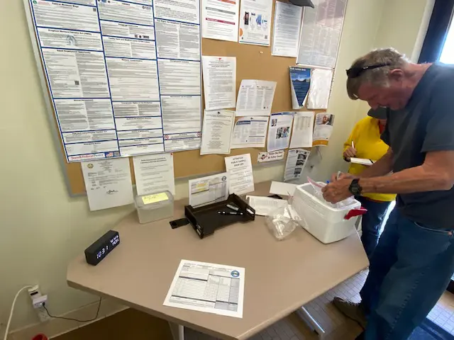 Ross Oswald prepares water samples for submission at Mono County offices.