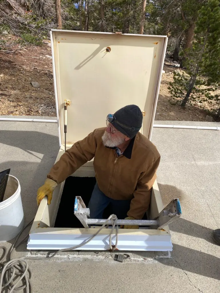 man climbing out of hatch